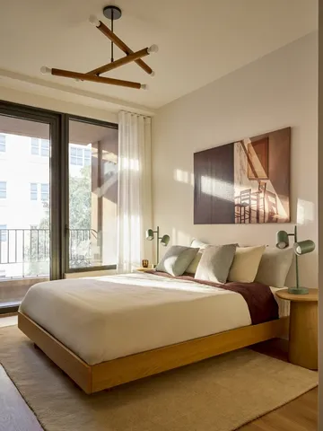 a bedroom with a large bed and a large window