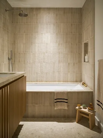 a bathroom with a bathtub and shower