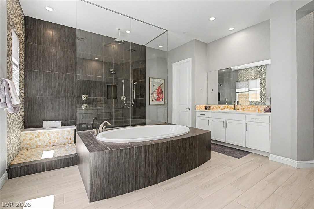 6014 Willow Ridge Court Las Vegas, NV 89135 - Photo 48 of 99 This spacious bathroom offers a relaxing soaking tub, a large shower, and a double vanity.
