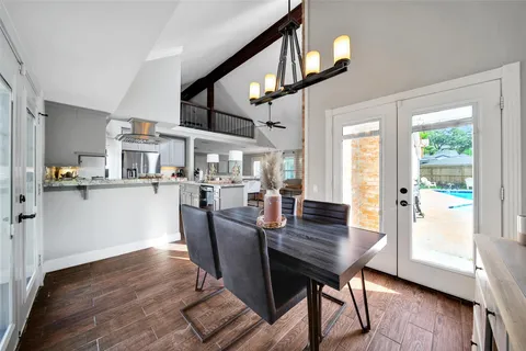 a dining room with furniture and wooden floor