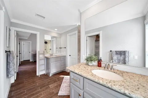 a spacious bathroom with a granite countertop sink and a mirror