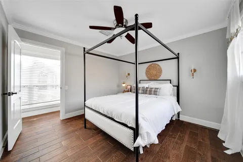 a bedroom with a bed and wooden floor
