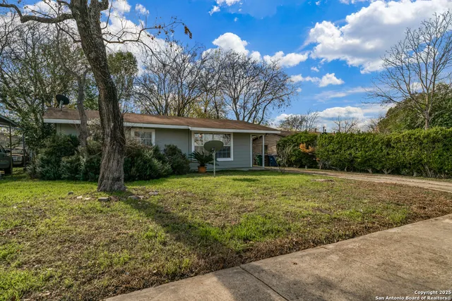 a view of a house with yard and tree s