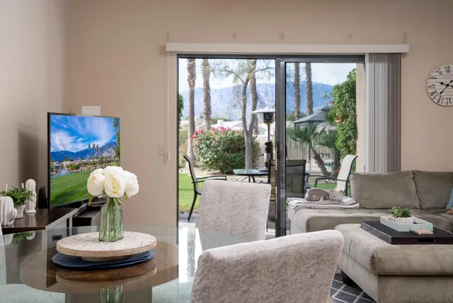 a living room with furniture and a large mirror