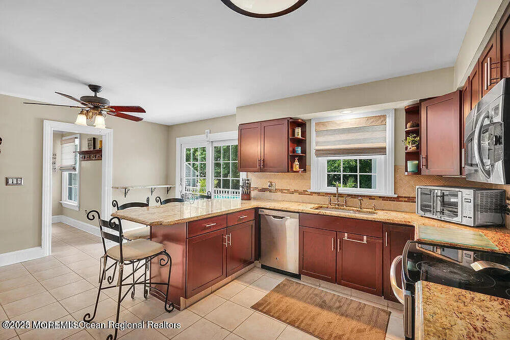 1722 Burrsville Road Brick, NJ 08724 - Photo 14 of 27 a large kitchen with a table and chairs in it