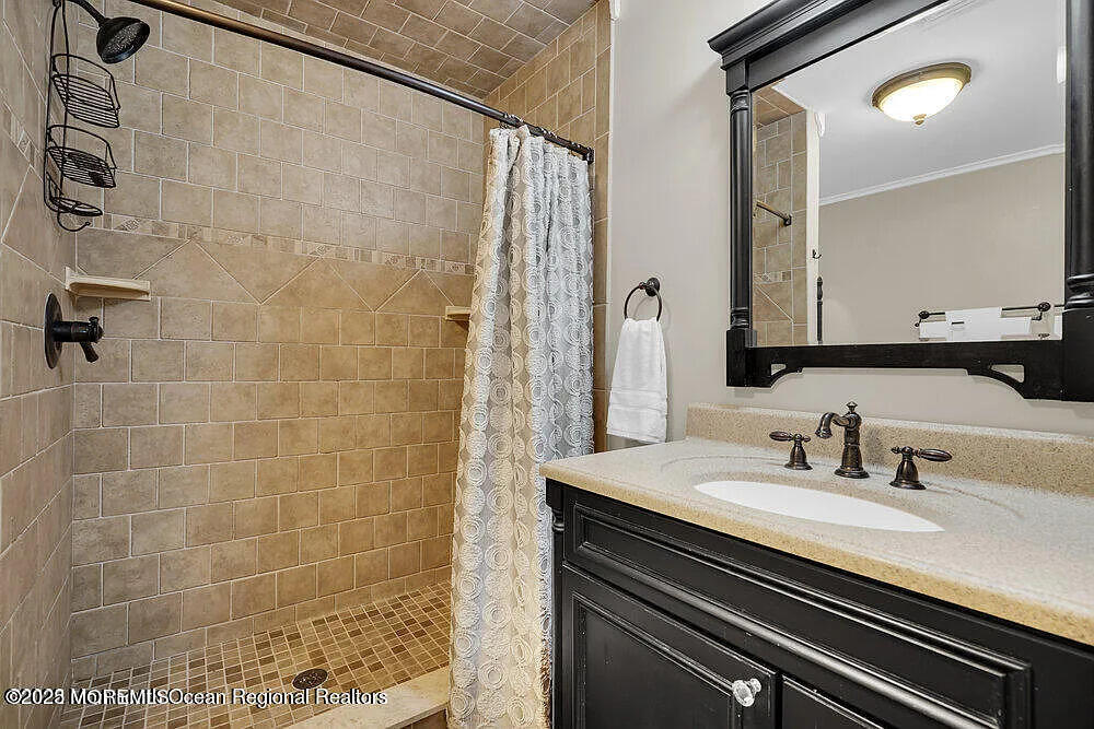 1722 Burrsville Road Brick, NJ 08724 - Photo 21 of 27 a bathroom with a sink and a mirror