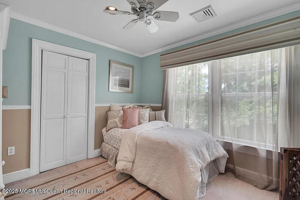 1722 Burrsville Road Brick, NJ 08724 - Photo 23 of 27 a bedroom with a large bed and a chandelier