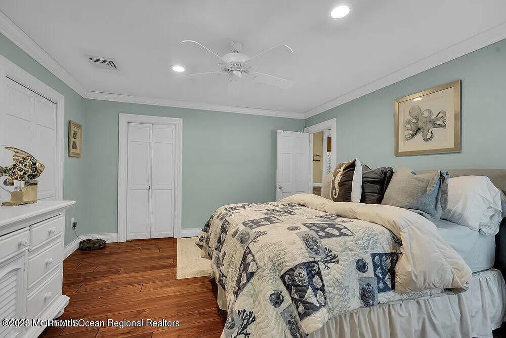 1722 Burrsville Road Brick, NJ 08724 - Photo 24 of 27 a bedroom with a large bed and a chandelier
