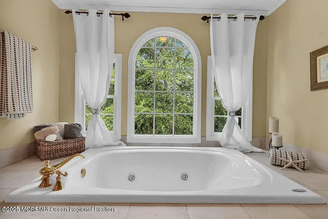 a bath tub sitting in a bathroom next to a window