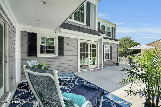 a view of a patio with table and chairs and potted plants