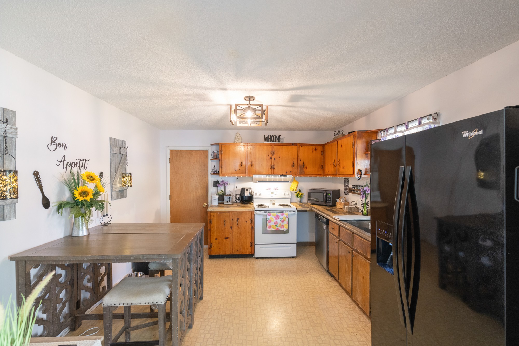 252 Luna Street Decaturville, TN 38329 - Photo 5 of 21 a kitchen with refrigerator and window