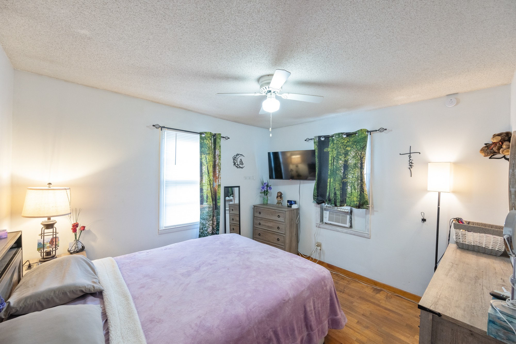 252 Luna Street Decaturville, TN 38329 - Photo 8 of 21 a bedroom with a bed and a flat screen tv