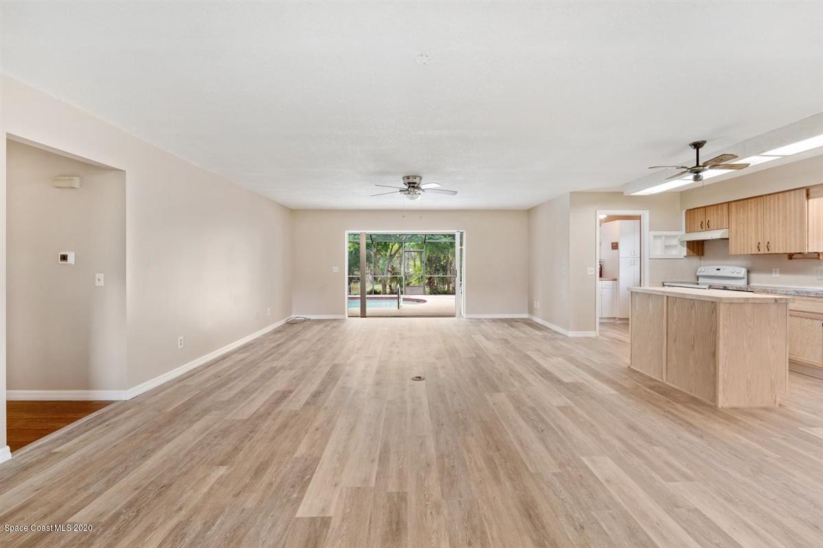 3600 Leghorn Road Grant Valkaria, FL 32950 - Photo 8 of 33 a view of a kitchen with wooden floor and a window