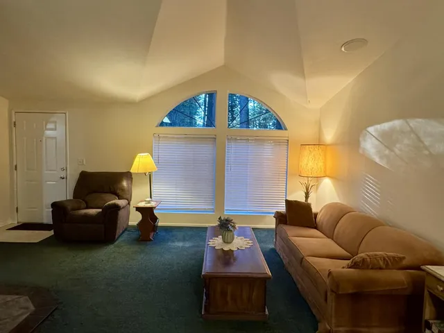 a view of a dining room with furniture and chandelier