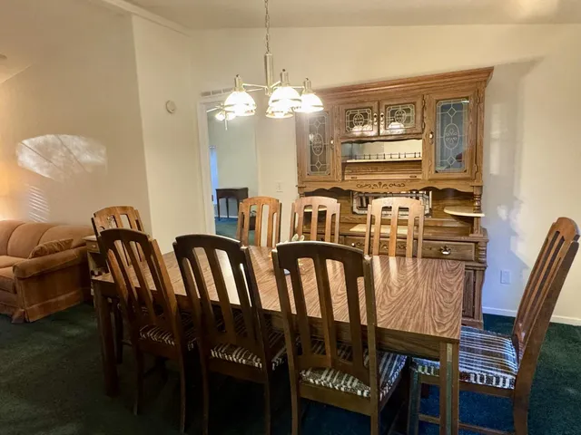 a kitchen with counter top space appliances and living room view
