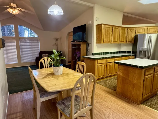 a living room with furniture and a dining table