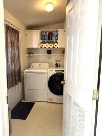 a spacious bedroom with a bed and a chandelier