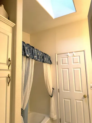 a living room with furniture and a ceiling fan