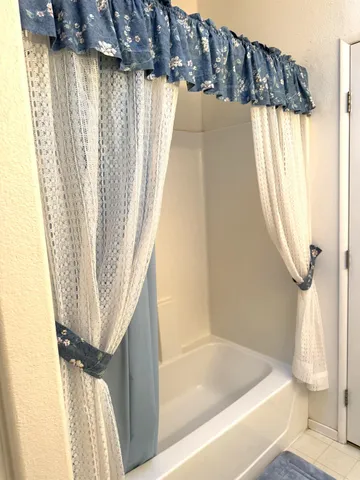 a bathroom with a bathtub and a window