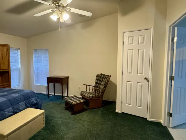 a bedroom with a bed and a painting on the wall