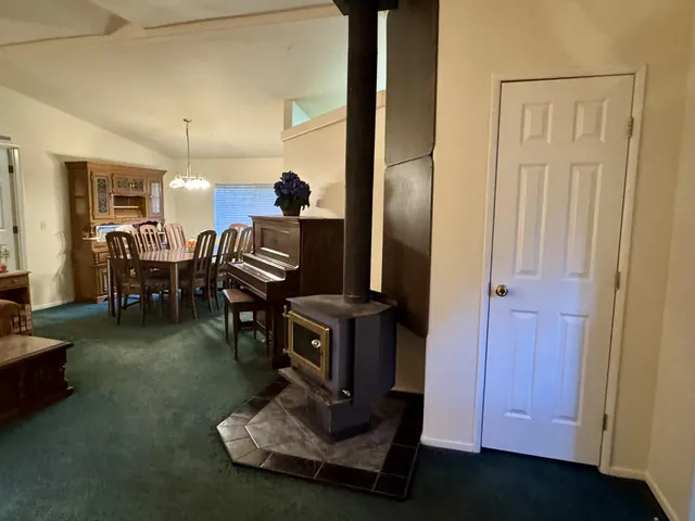 a living room with furniture a fireplace and a window