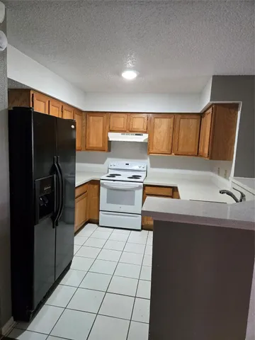 a kitchen with stainless steel appliances a refrigerator sink and cabinets