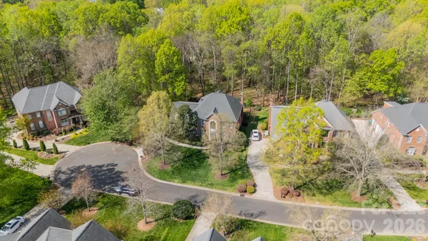 an aerial view of a house with garden space and sitting area