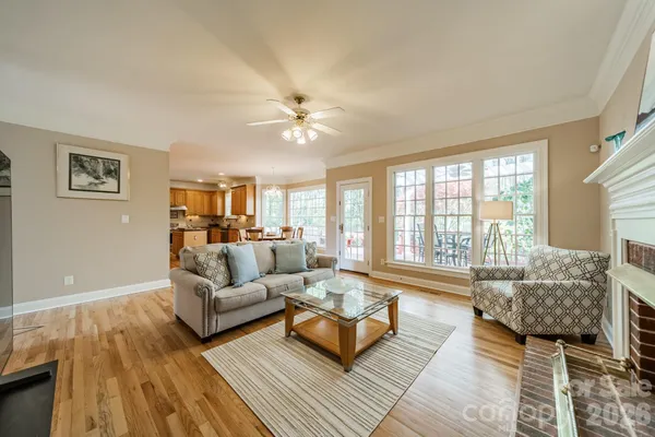 a living room with furniture fireplace and flat screen tv