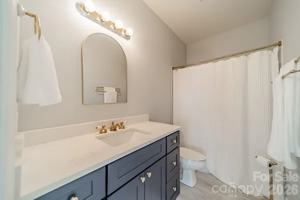 a large bathroom with a double vanity sink a large mirror and a bathtub