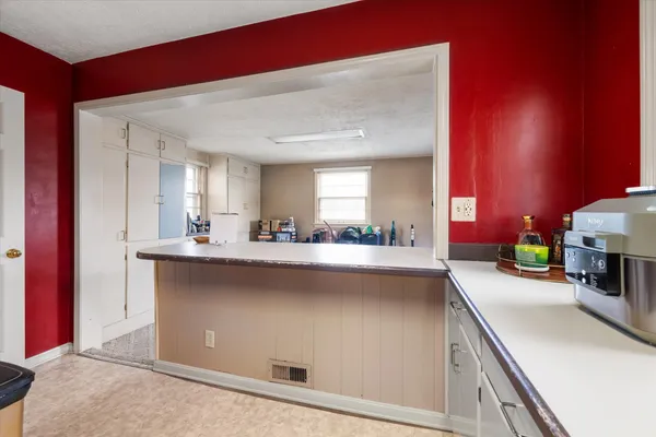 a kitchen with stainless steel appliances a sink stove and cabinets