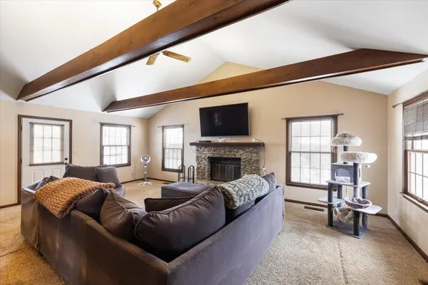 a living room with fireplace furniture and a flat screen tv