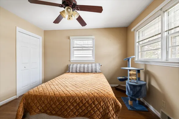 a bedroom with a bed and a window