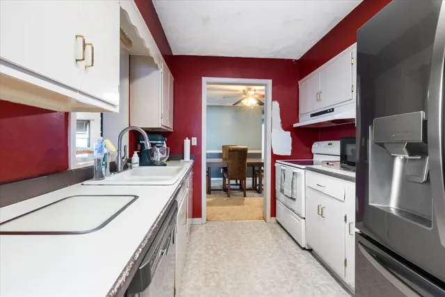a kitchen with a sink stove and cabinets