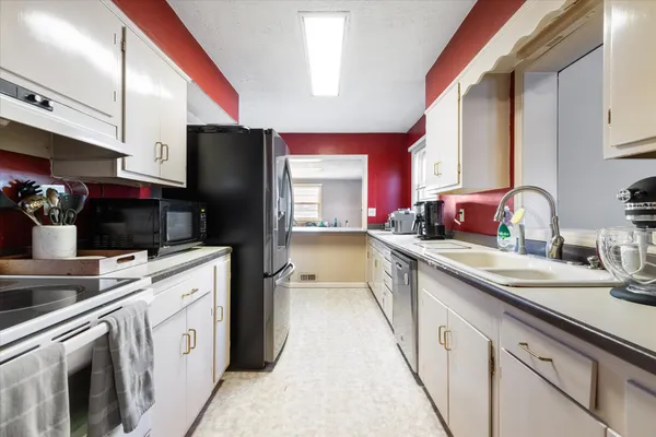 a kitchen with a sink and refrigerator