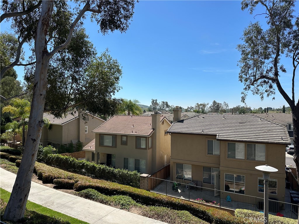 8514 East Baker Hill Road, Unit B Orange, CA 92869 - Photo 14 of 19 a front view of a house with plants and tree