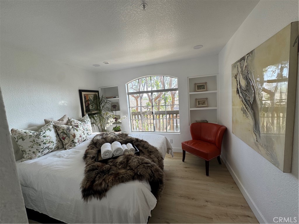 8514 East Baker Hill Road, Unit B Orange, CA 92869 - Photo 5 of 19 a bed sitting in a bedroom next to a window