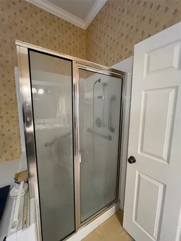 a bathroom with a glass door shower