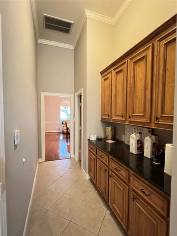a kitchen with granite countertop a sink dishwasher stove and cabinets