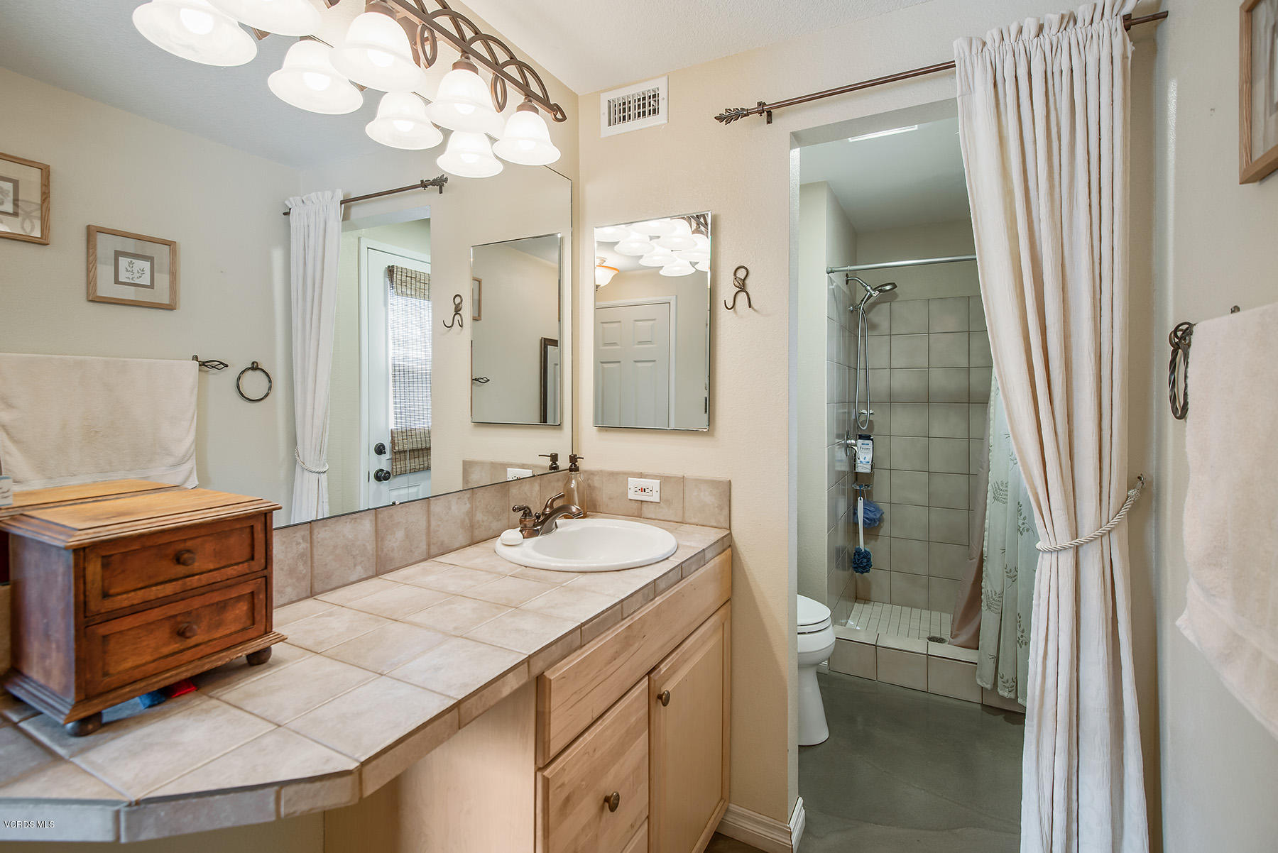 2974 Racine Street Simi Valley, CA 93065 - Photo 22 of 30 a bathroom with a granite countertop sink a mirror and a shower