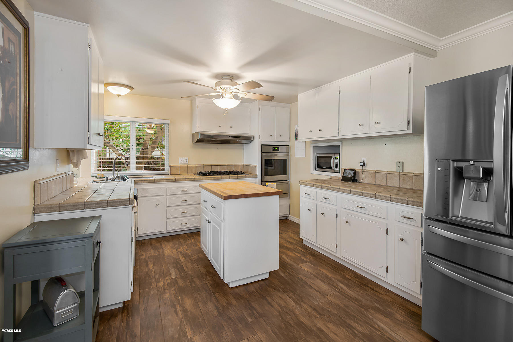2974 Racine Street Simi Valley, CA 93065 - Photo 4 of 30 a kitchen with cabinets stainless steel appliances and wooden floor