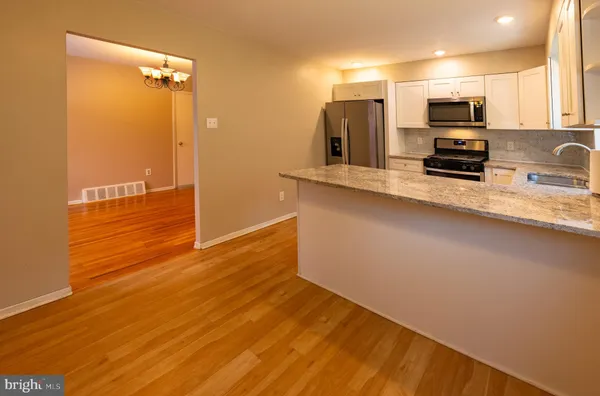 a view of a kitchen with a sink and a microwave