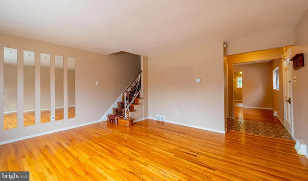 a view of an empty room with wooden floor