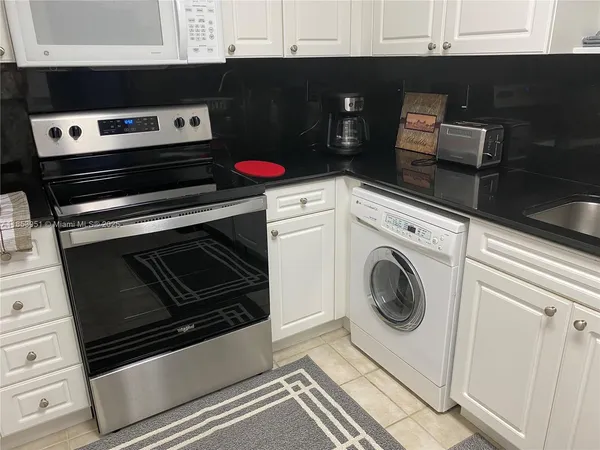 a kitchen with a stove and a microwave