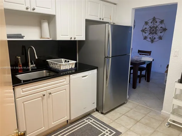 a kitchen with stainless steel appliances granite countertop a refrigerator and a stove