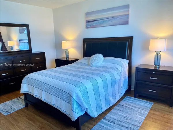 a bedroom with a bed and a lamp