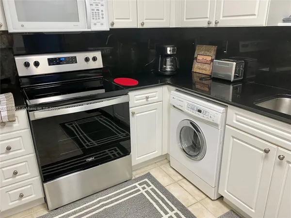 a kitchen with a stove and a microwave
