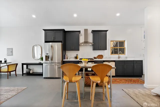 a view of a dining room with furniture and a kitchen