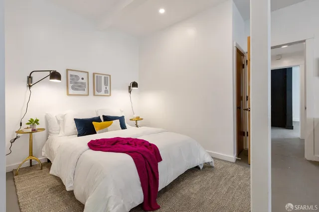 a bedroom with a bed and a lamp