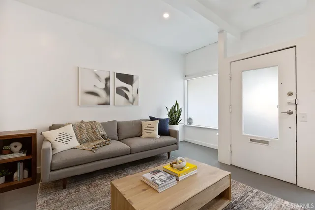 a living room with furniture and a rug