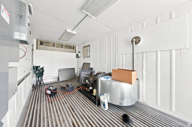 1063 West Kolob Ranch Drive Springdale, UT 84767 - Photo 34 of 61 Utility space featuring corrugated metal walls and flooring, overhead fluorescent lighting, and visible mechanical equipment